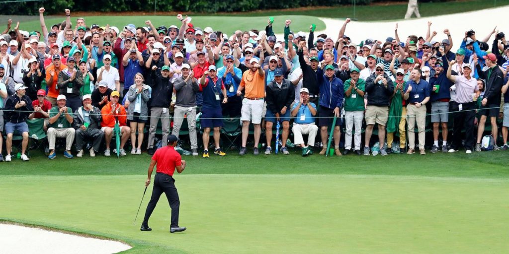 Tiger Woods celebrates his Masters victory in front of the spectators on the 18th green at Augusta