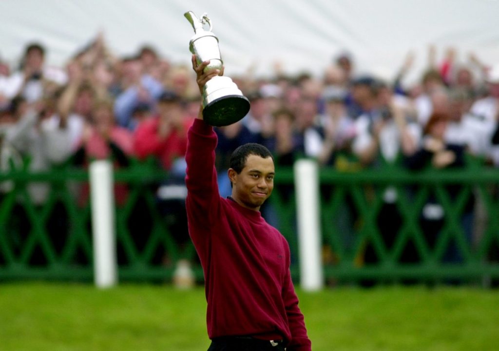 Tiger Woods holds the Claret Jug aloft after winning the Open golf championship with a final score of 19 under par at St. Andrews, Scotland in 2000