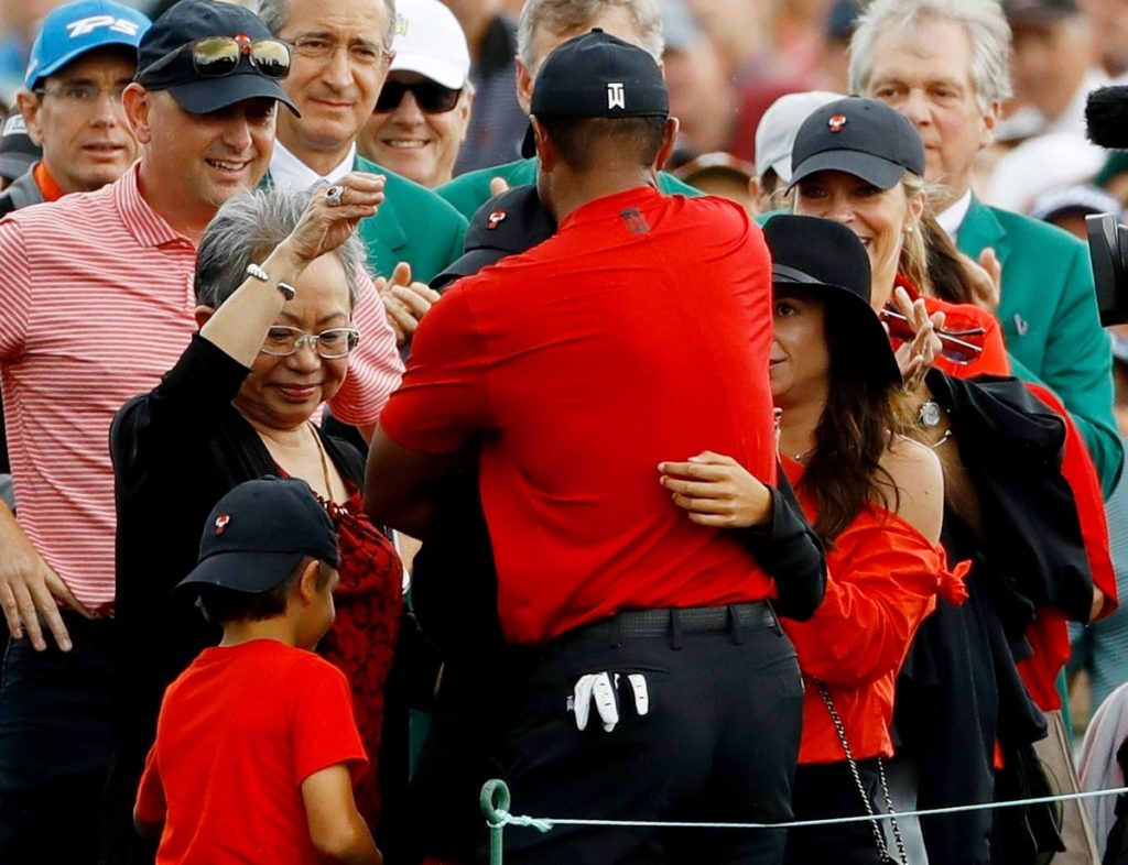 Tiger Woods hugs his family after sealing an emotional victory