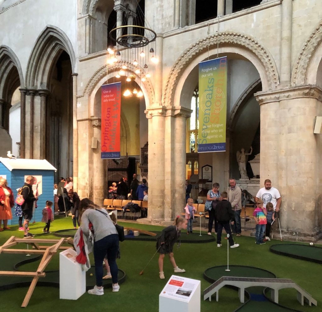 Crazy Cathedral - Rochester. Amid some controversy, a 9-hole crazy golf course has been laid out in the central aisle of the medieval cathedral