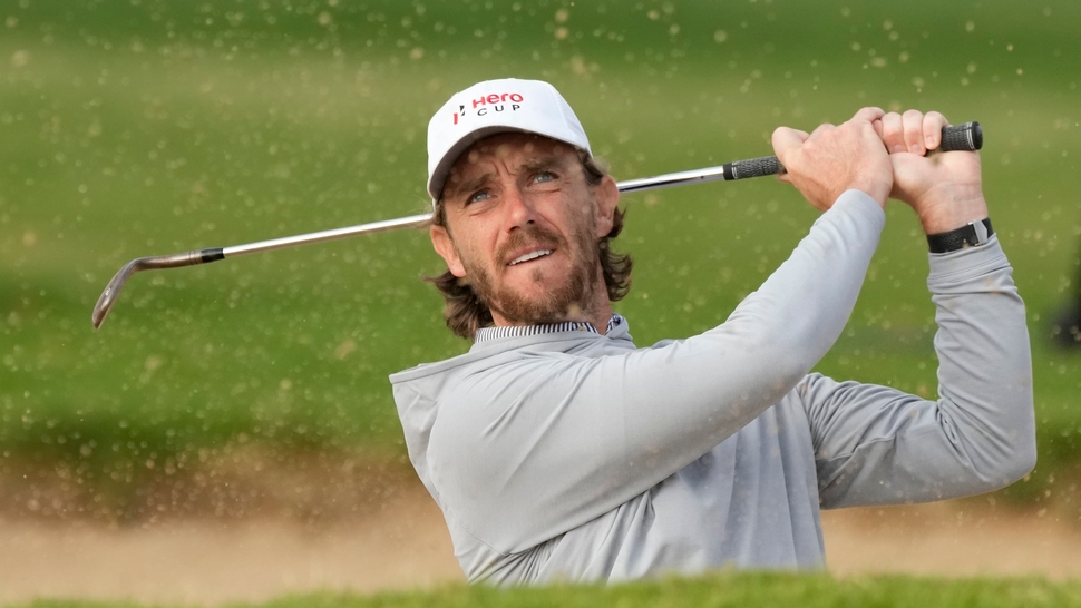 Tommy Fleetwood plays out of a bunker at the Hero Cup