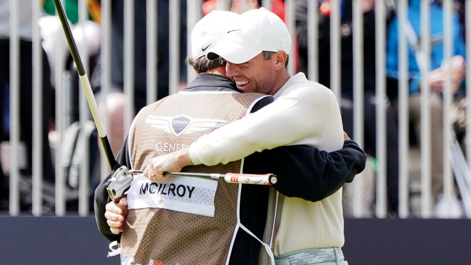 Rory McIlroy celebrates with caddie Harry Diamond after winning the Genesis Scottish Open