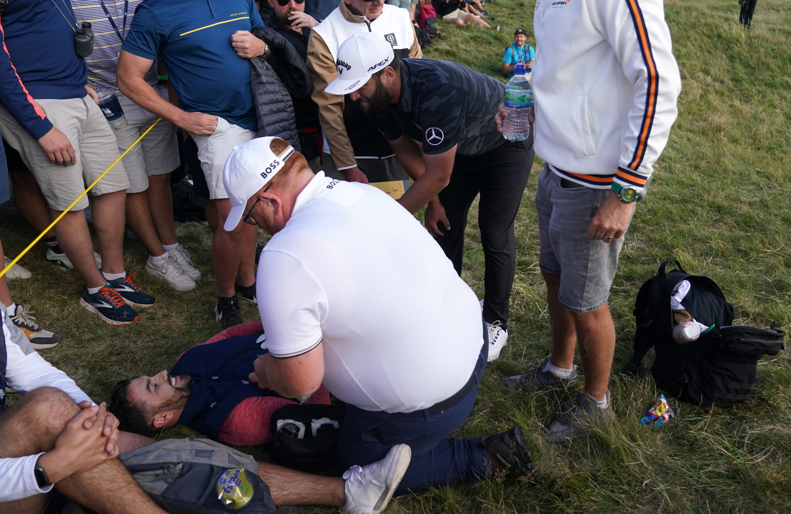 Jon Rahm checks on the health of a fan he hit with his ball