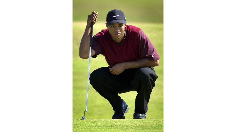 Tiger Woods checks the lie of the green during the last day of the 2000 Open Championship at St. Andrews, Scotland