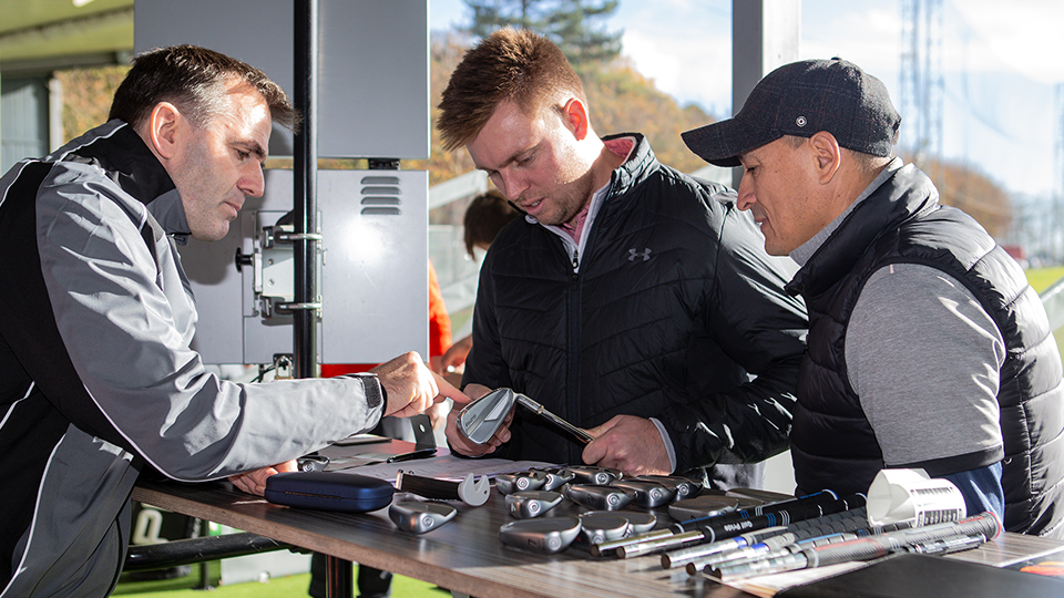 Two PGA coaches teaching a newly qualified professional about club repairs