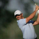 Rory McIlroy hits his second shot on his opening hole
