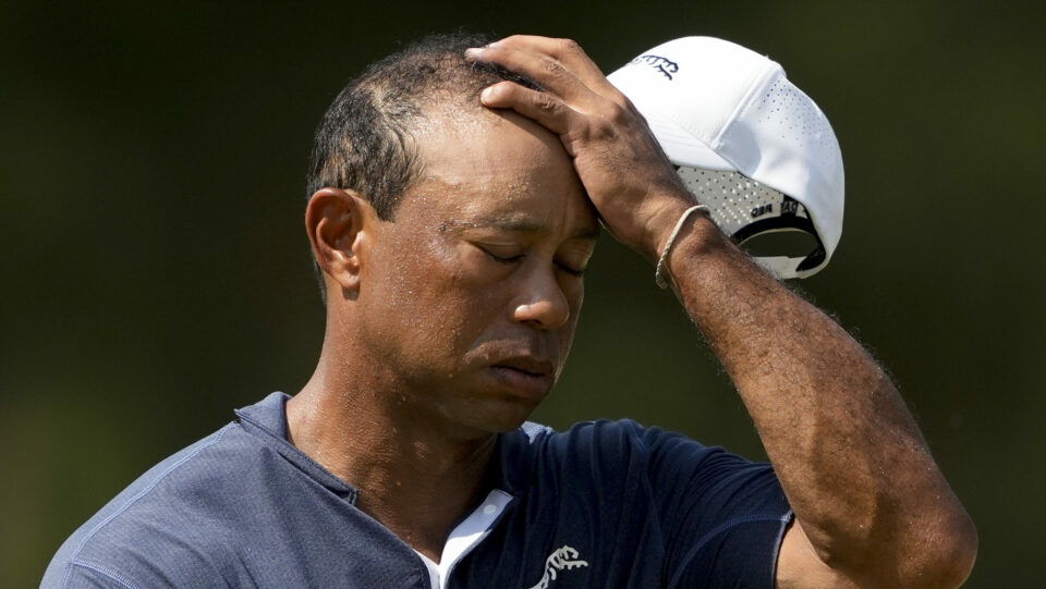 Tiger Woods wipes his face on a hot day two of the US Open