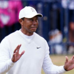 Tiger Woods raises his hands at the 2022 Open