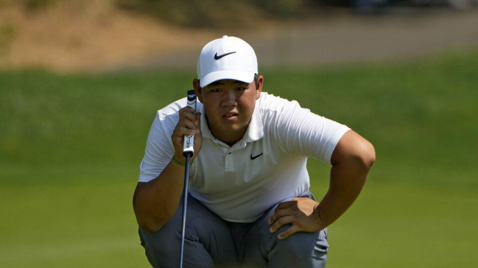 Tom Kim lines up a putt on the 15th hole at the Travelers Championship