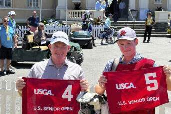 Frank Bensel and son Hagen hold pin flags at the US Senior Open