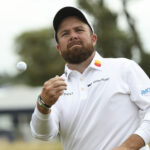 Shane Lowry throws a ball to spectators