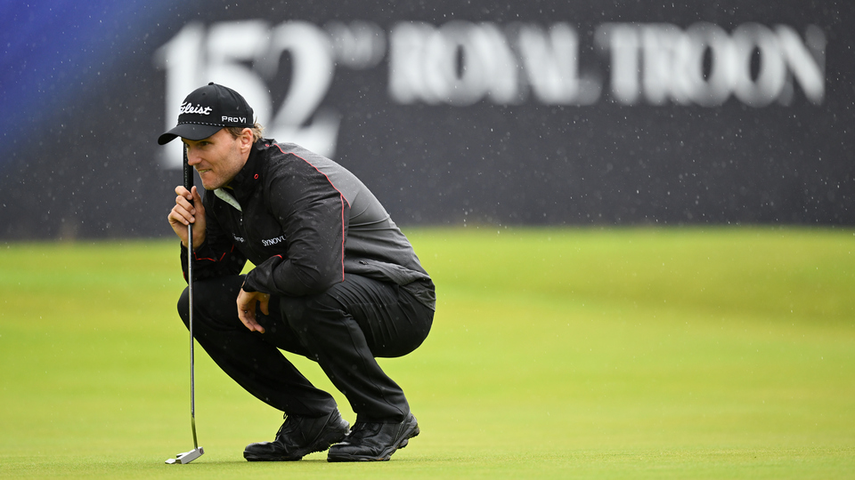 Russell Henley of the United States lines up putt on the 18th green