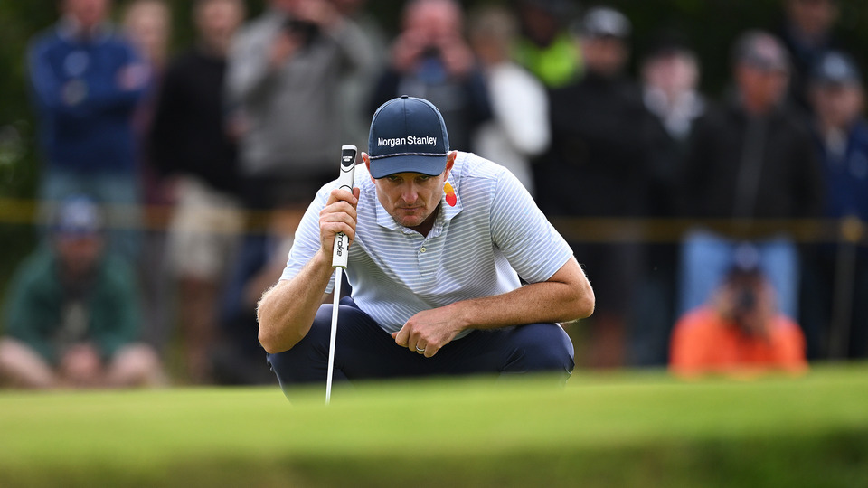 Justin Rose of England lines up a putt on the 16th green on day two of The 152nd Open championship at Royal Troon