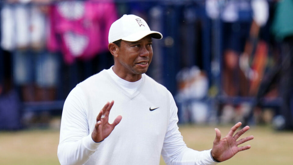 Tiger Woods raises his hands while playing at St Andrews in the 2022 Open