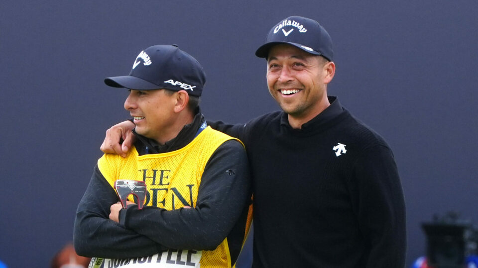 Xander Schauffele puts his arm around his caddie after winning The 152nd Open at Royal Troon