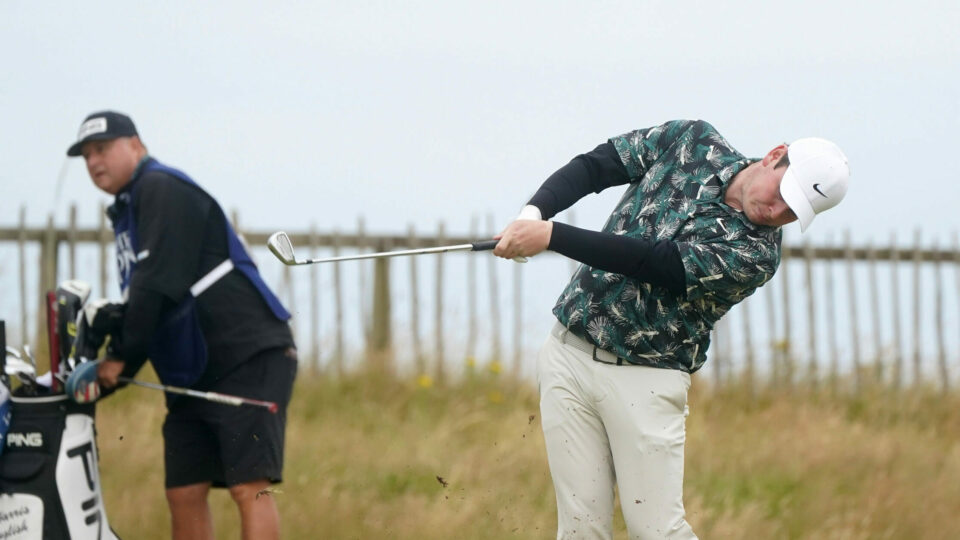 Scotland’s Robert MacIntyre hit an iron off the fairway watched by his caddie on day three of The Open
