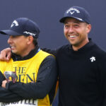 Xander Schauffele puts his arm around his caddie after winning The 152nd Open at Royal Troon