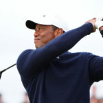 Tiger Woods watches his second shot on the fourth hole