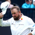 Shane Lowry raises his cap after a birdie on the 18th