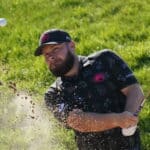 Tyrrell Hatton splashes out of a bunker