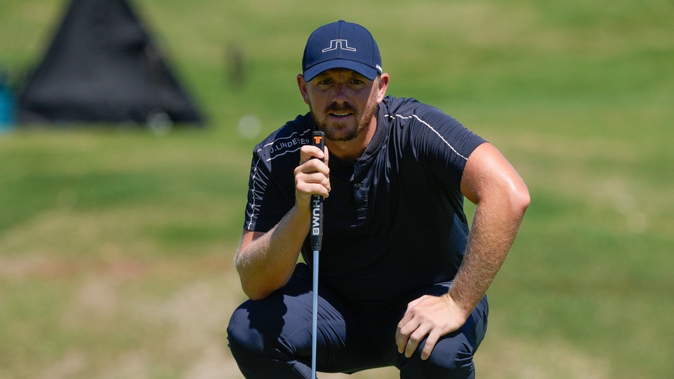 Matt Wallace studies his putt at the 9th green during the second round of the Mexico Open golf tournament in Puerto Vallarta