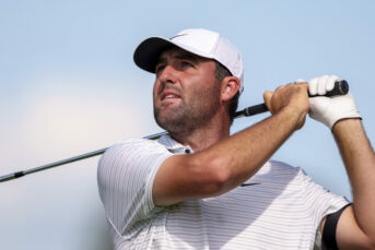 Scottie Scheffler hits his tee shot on the ninth hole