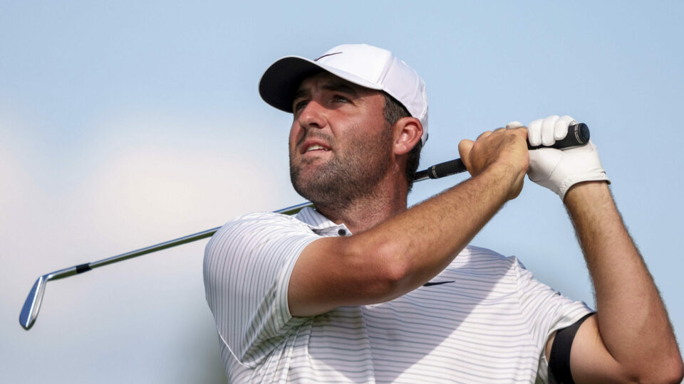 Scottie Scheffler hits his tee shot on the ninth hole